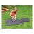 Woman assembling Intex gray puzzle mats on lawn