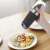 Ruhhy electric salt and pepper grinder, black, with blue LED light, showing salt and peppercorns inside