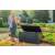 Woman putting items in Keter Emily 270L storage box in a garden setting