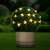 Solar powered bee shaped LED fairy lights, 20 warm white LEDs, 2.3 meters long, decorating a bush in a garden at night