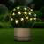 Solar powered bee shaped LED fairy lights, 20 warm white LEDs, 2.3 meters long, decorating a bush in a garden at night