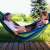 Two girls relaxing in a Gardlov Kerti XXL blue and green striped hammock