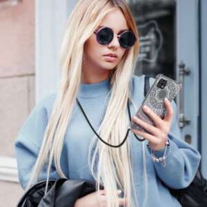 kwmobile Samsung Galaxy A22 5G phone case with lanyard, woman wearing the case and using the phone - Phone Case