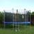 Springos trampoline safety net in use, 305cm diameter, black net, blue frame, children jumping