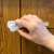 Hand installing Springos white cabinet and drawer lock on a cabinet