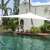 Pepita Deluxe 3x3x3m triangular shade sail in white, installed over a pool