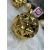 Springos gold geometric Christmas tree ornament on white fur, close-up