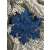 Blue glitter snowflake Christmas ornament on a Christmas tree