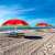Springos watermelon beach umbrellas on a sandy beach
