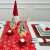 Red and white snowflake table runner with Christmas decorations on a table