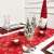 Red and white snowflake table runner with Christmas decorations on a table