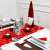 Red and white snowflake table runner with Christmas decorations on a table