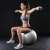 Woman using dumbbells for workout on a fitness ball