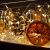 Decorative arrangement with Springos LED string lights, pine cones, and dried orange slices