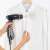 Rayen 6222 handheld garment steamer in use, removing wrinkles from a white shirt