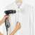 Rayen 6222 handheld garment steamer in use, removing wrinkles from a white shirt