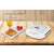 ECG S 3271 sandwich maker, white, closed, non-stick plates, on a wooden table with a plate of toasted sandwiches and a glass of juice