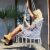 Woman relaxing in Springos grey macrame hanging chair on patio