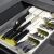 Springos green cutlery organizer in drawer with knives, forks, and spoons