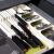 Springos green cutlery organizer in drawer with knives, forks, and spoons