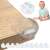 Springos clear silicone corner protector for furniture on a table corner with a baby sitting on the floor