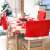 Springos Santa Hat Chair Covers on chairs around a Christmas table