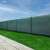 Springos Shade Net, green, 1x25m, 140g/m2, installed on a fence