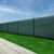 Springos green shade net installed on a fence for privacy and sun protection