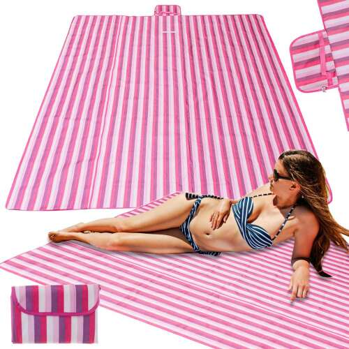 Pink striped beach blanket with woman laying on it