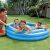 Inflatable kiddie pool with children playing in the water