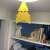 Yellow sticky insect trap for plants, butterfly shape, hanging from a ceiling