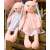 Two pink plush bunny rabbits with dresses, 52cm, sitting on a wooden surface