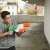 Boy playing with Nerf Super Soaker Hydro Frenzy water blaster, green and orange