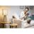 Frau entspannt mit Ledvance Smart+ Lampe und Smart Speaker