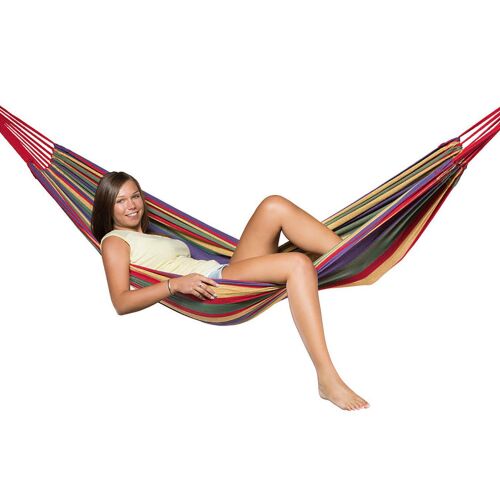 Woman relaxing in a striped hammock