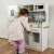 Kruzzel wooden play kitchen with LED lighting and accessories, child playing with pan