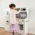 Kruzzel wooden play kitchen with LED lighting and accessories, child playing