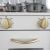 Close-up of Játékkonyha wooden toy kitchen oven with gold knobs and cookware