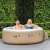 Couple enjoying Intex PureSpa inflatable hot tub in garden