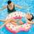 Girl using Intex Rainbow Donut Inflatable Swim Ring in a pool