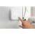 Meross MTS200HK Wi-Fi smart thermostat, white, installed on a wall, being touched