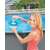 Woman adding chlorine tablet to Intex floating chemical dispenser for pools