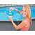 Woman adding chlorine tablet to Intex floating chemical dispenser for pools