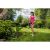Woman using Riwall PRO RALT 2320 cordless grass trimmer in garden