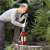 Man using Einhell GE-PP 1100 N-A submersible pump to pump water from a well