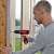 Man using Einhell TH-CD 12-2 Li cordless drill screwdriver for DIY projects