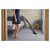 Woman using Sencor SVC 0741YL cordless stick vacuum cleaner on carpet