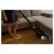 Woman using Sencor SVC 0741YL cordless stick vacuum cleaner on hardwood floor
