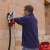 man using Einhell TH-MA 1300 wall chaser with dust extraction