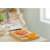 Fiskars Classic kitchen shears, 18 cm, orange handles, on a wooden cutting board